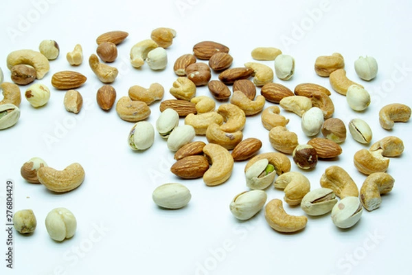 Obraz nuts almonds cashew hazelnuts scattered on white background