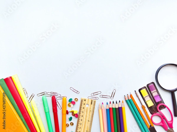 Fototapeta Colorful  school suplies against light blue background with copy space. Back to school concept, top view.