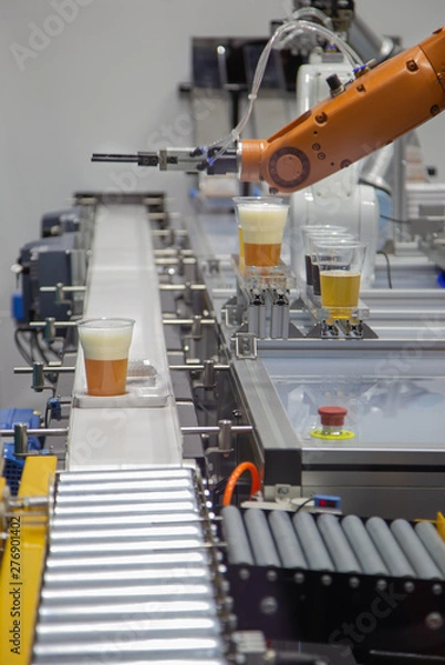 Obraz Robot pouring beer to a glass and serve on conveyor. Industrial technology