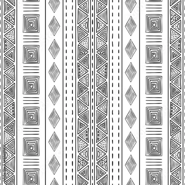 Fototapeta Black and white vector tribal seamless pattern with vertical lines, triangles, and diamonds shapes. Trendy ethnic geometric print for wallpaper, textile, packaging. Hand-drawn look elements.