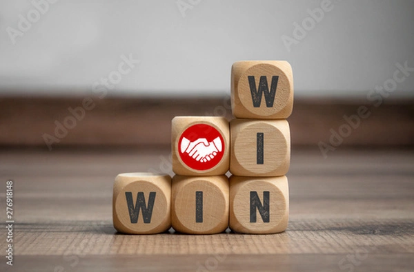 Obraz Cubes and dice with handshake icon and win-win-situation on wooden background