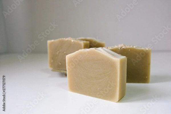 Fototapeta Natural oatmeal soap is placed on a white background.
