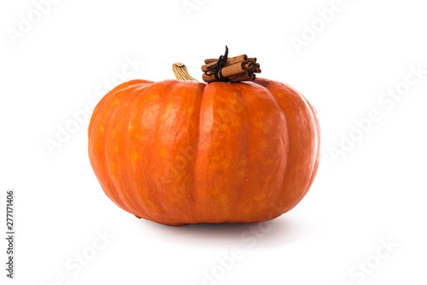 Fototapeta Pumpkin spice latte concept. Large pumpkin and cinnamon sticks, isolated over white
