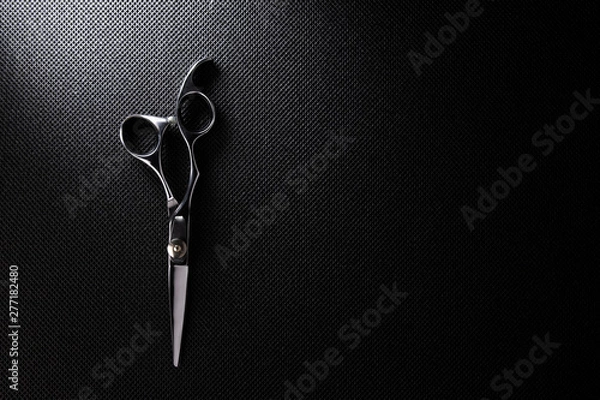 Obraz professional scissors on black background