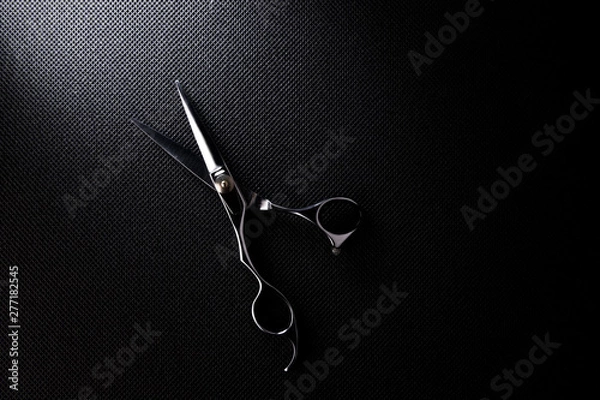 Obraz professional scissors on black background