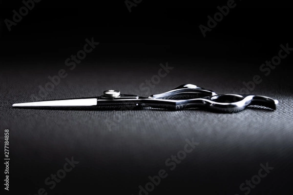 Obraz professional scissors on black background