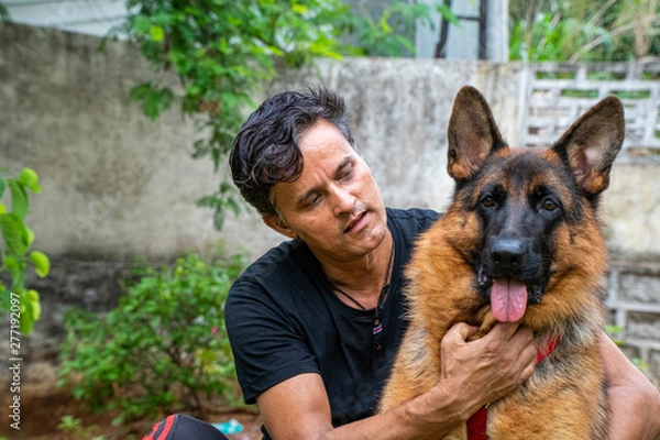 Obraz German Shepherd with Handler in Garden