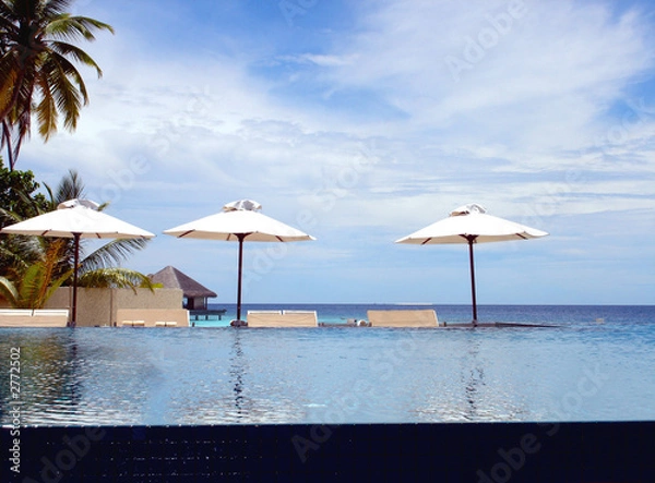 Fototapeta sitting by the pool in the maldives