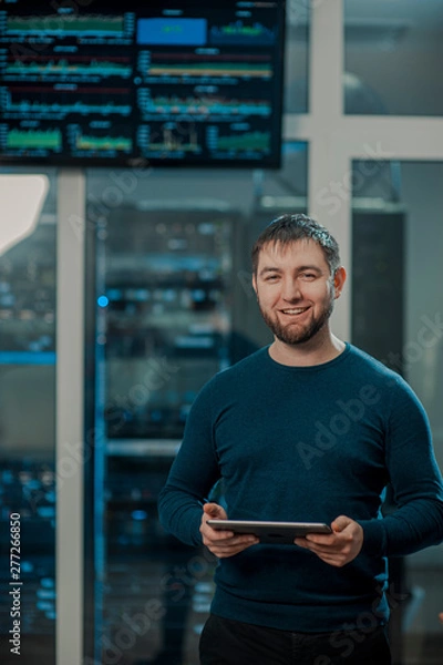 Fototapeta network engineer working in server room