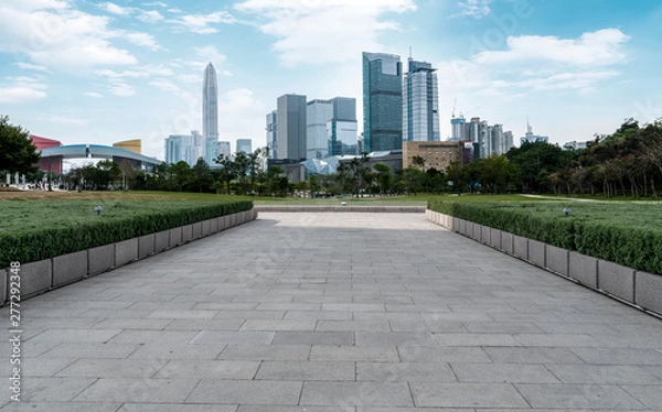 Fototapeta Empty square tiles and skyline of urban Architecture