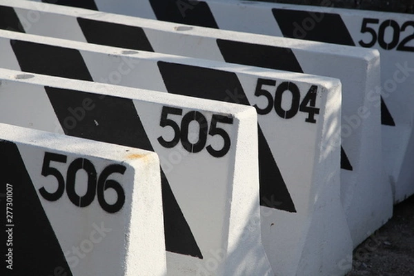 Fototapeta Road blocks with painted numbers in sequence
