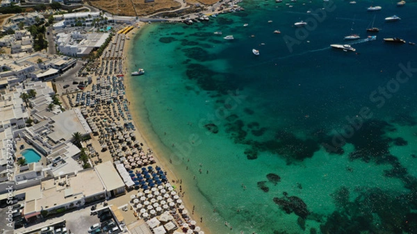 Fototapeta Aerial drone photo of paradise celebrity bay of Ornos famous for pool resorts and sandy turquoise organised clear sea beach, Mykonos island, Cyclades, Greece