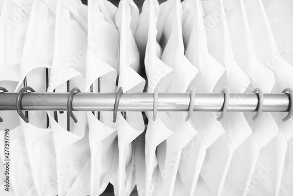 Fototapeta Row of cloth hanger with shirts