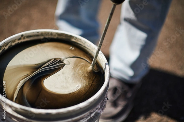 Obraz Mixing paint in a bucket