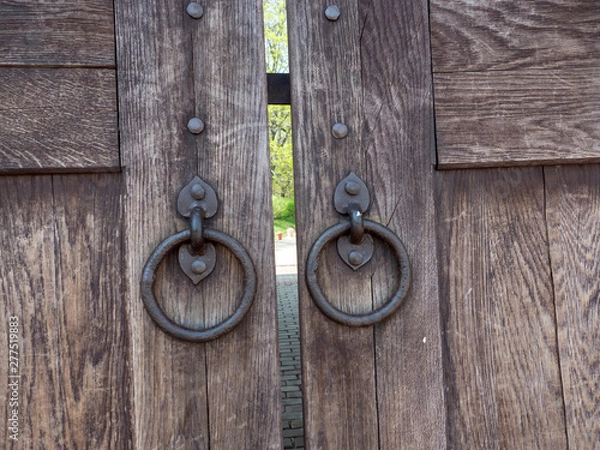 Fototapeta Old Wooden Gate with wrought iron rings    Solid oak old gate made of wood