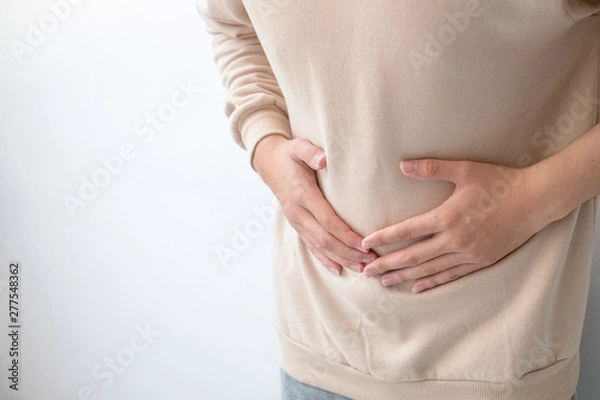 Fototapeta Men with abdominal pain standing, holding the body and hands Photos, concepts of health and medical care