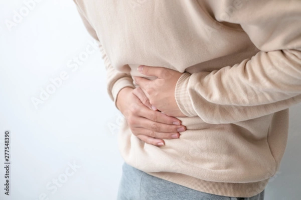 Fototapeta Men with abdominal pain standing, holding the body and hands Photos, concepts of health and medical care