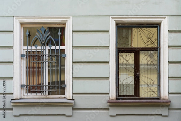 Fototapeta two windows behind bars in an old house