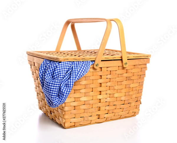 Fototapeta A brown wicker picnic basket on a white background with gingham cloth