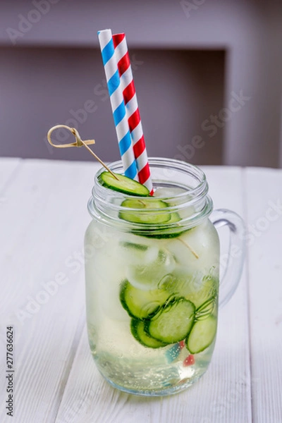 Obraz Fresh cold cocktail with cucumbers in misted glass. Non-alcoholic summer lemonade. Vegetarian menu of cafe or restaurant
