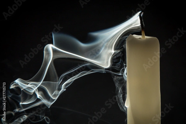 Obraz Smoke and extinct candle on a black background