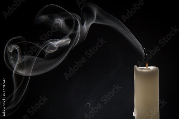 Obraz Smoke and extinct candle on a black background
