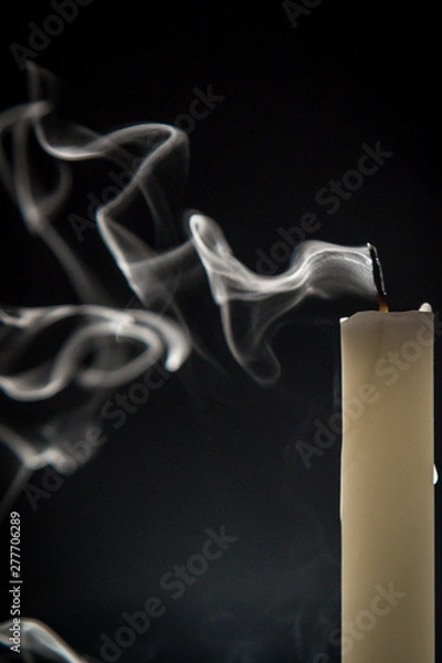 Obraz Smoke and extinct candle on a black background