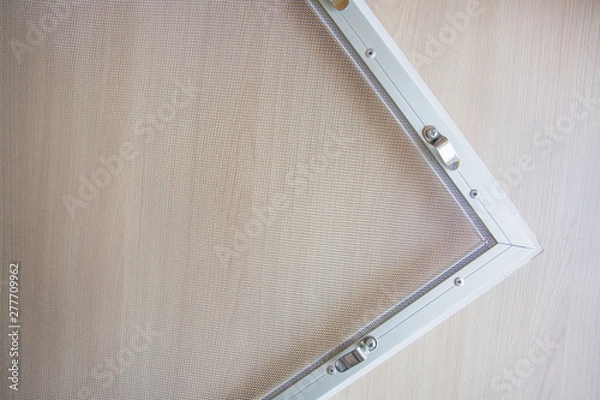 Fototapeta anti-mosquito protective mesh with mounts on the window shot close-up