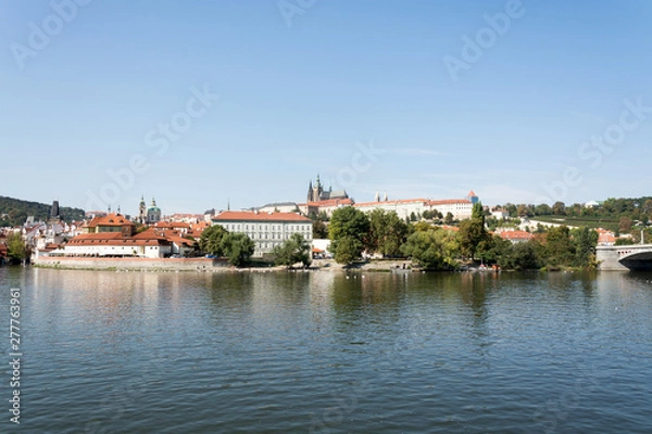Obraz Panoramic view of Vltava river, Prague castle, and colorful rooftops of New Town on a bright summer day, in Prague, Czech Republic