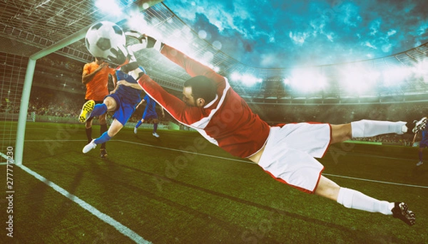 Fototapeta Goalkeeper catches the ball in the stadium during a football game