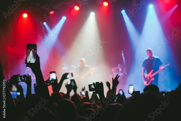 Obraz Raised up hands with cellphones recording videos from music show