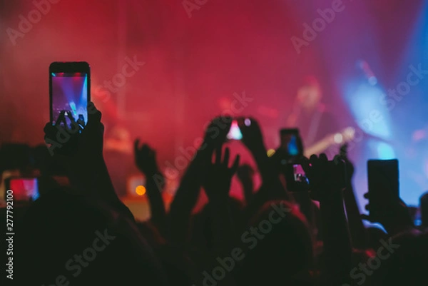 Obraz Raised up hands with cellphones recording videos from music show