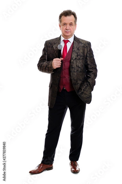 Fototapeta Full length body of happy and successful senior man 60-65 years old. Businessman senior stand in beautiful suit with red tie and white shirt. Grinning Man hold microphone. Isolated on white background