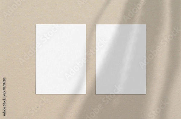 Fototapeta Blank white vertical paper sheet 5x7 inches with shadow overlay. Modern and stylish greeting card or wedding invitation mock up.