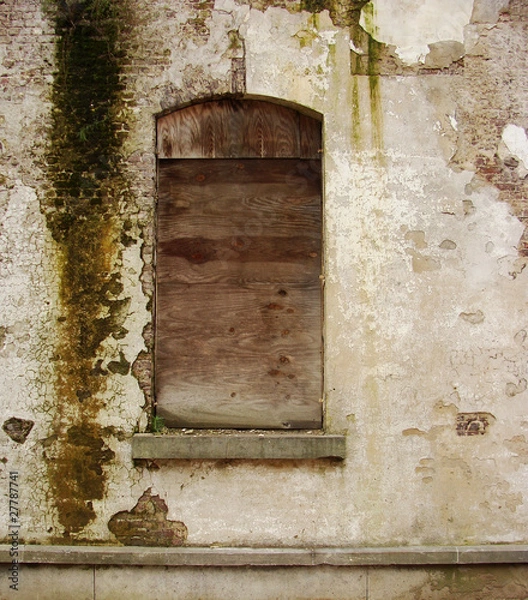 Fototapeta closed down windown of an abandoned building