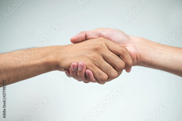 Fototapeta Holding hands of two men on a white background,Friends,Dear friend,Relationship