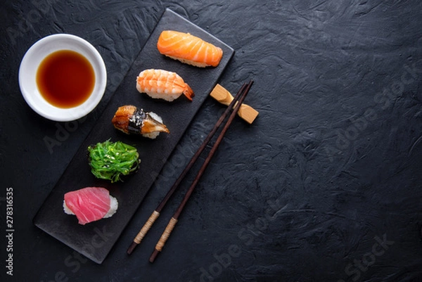 Fototapeta Set of sushi on dark stone table. Top view