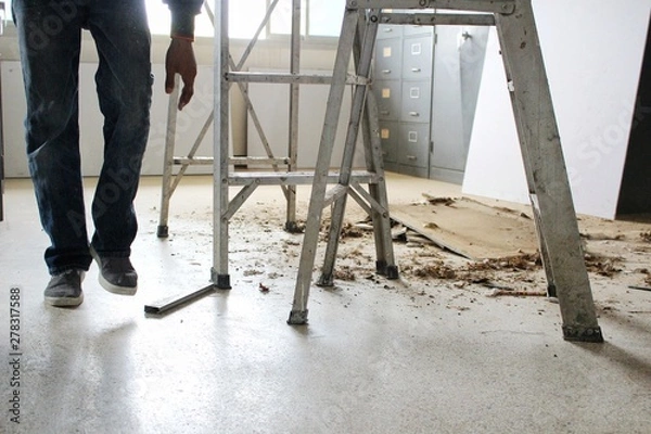 Fototapeta Aluminum ladders are on the floor and ceiling debris and large amounts of dust, blurred photographs