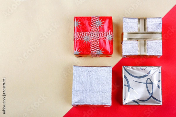 Obraz Golden gift box on red background.Top view flat lay group objects