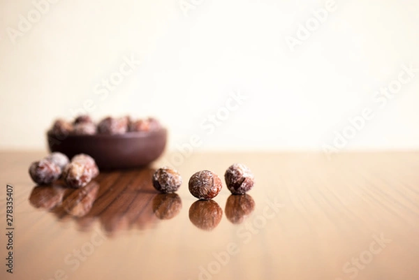 Fototapeta Hazelnuts, filbert in burlap sack on wooden backdrop. heap or stack of hazelnuts. Hazelnut background, healty food