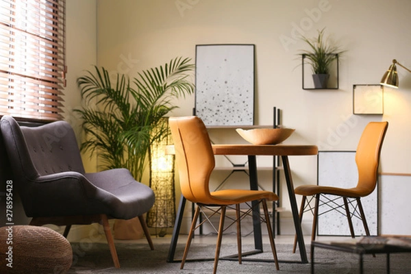 Fototapeta Stylish dining room interior with modern table set and window blinds