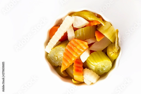 Obraz Assorted pickles vegetables carrot, chili, radish in white ceramic bowl. Top view. Isolated. Copy space. Top view.