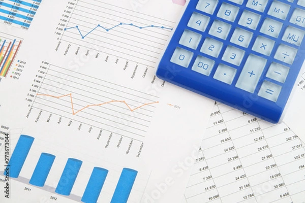 Fototapeta Business concept, calculator on financial charts and graphs