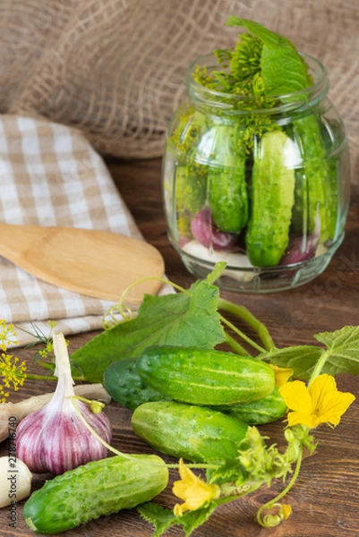 Obraz pickled cucumbers on a wooden background