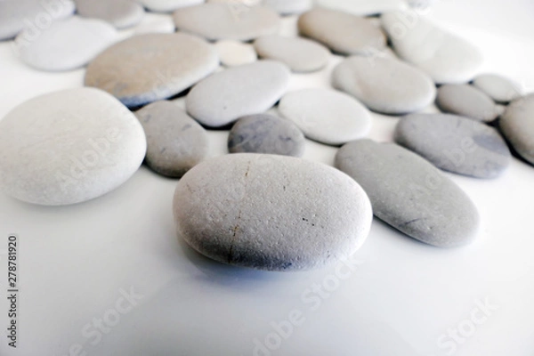 Fototapeta Round Gray Stones isolated on a White Background