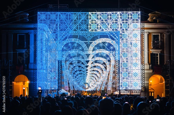 Fototapeta Crowd looking a light and music performance at night during Cuneo Illuminata (Illuminated Cuneo), traditional public fair in Cuneo (Piedmont, Italy)