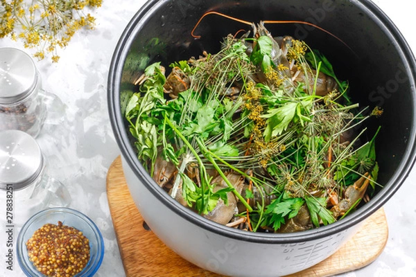 Obraz Fresh crayfish in a bowl of the multicooker with herbs on a concrete background - ingredients for cooking boiled crawfish in a slow cooker. Step 3.