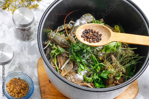 Obraz Fresh crayfish in a bowl of the multicooker with salt and black peppercorns - ingredients for cooking boiled crayfish in a multicooker. Step 4.