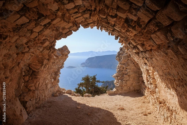 Fototapeta Sea skyview landscape photo from ruins of Monolithos castle on Rhodes island, Dodecanese, Greece. Panorama with green mountains and clear blue water. Famous tourist destination in South Europe