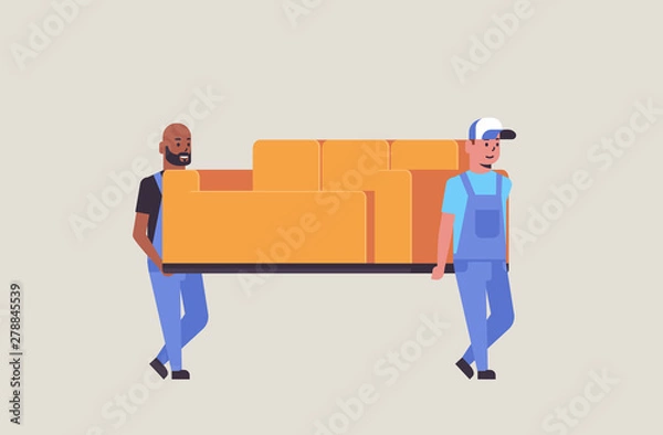 Obraz two mix race couriers in uniform moving couch express delivery service concept professional furniture movers holding new sofa flat full length horizontal